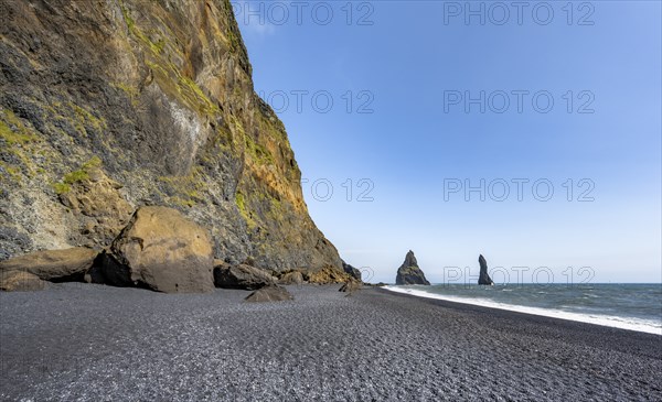 Black beach with cliffs, rock Reynisdrangar in the water, at Reynisfjara beach, Vik, South Iceland,