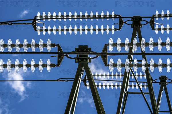 Insulators made of glass on a high-voltage line, they hang on the pylons as a suspension device