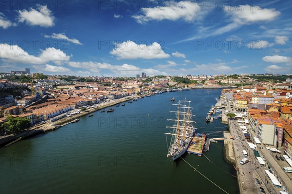 Aerial view of Porto city and Vila Nova de Gaia and Douro river with moored sailling ship from Dom