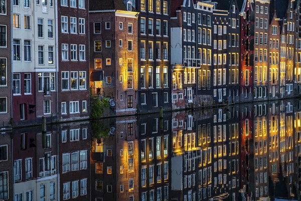 Canal houses on the Damrak, in the centre of the old town of Amsterdam, harbour, starting point of