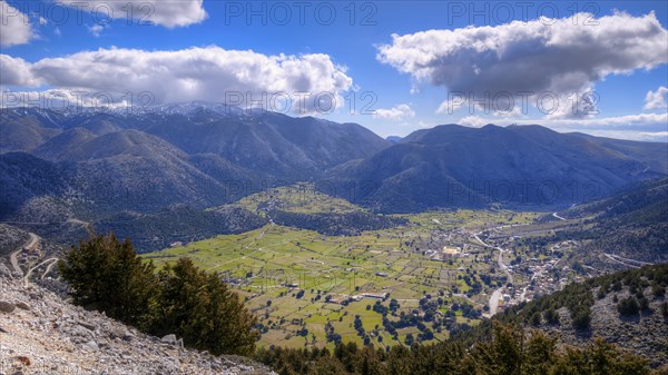 Mountainous landscape with serpentines, meadows and settlements, partially shaded, Askifou plateau,