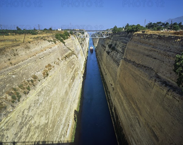 A cargo ship travels through a canal-like waterway with steep, dry walls, Corinth Canal, Corinth,