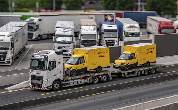 Car transporter with 2 new delivery vehicles for Deutsche Post, DHL, electric vehicles, on the A2