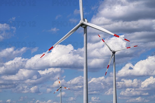 Wind turbine, wind energy plant from the manufacturer Enercon, blue sky with many white clouds,