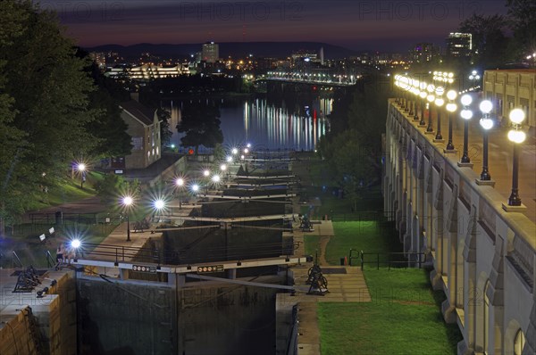 Night scene of a city on a river with illuminated locks and buildings, Rideau Canal, Ottawa,