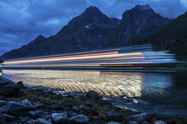 Hurtigruten cruise ship passes the Raftsund at night, long time exposure, the strait between