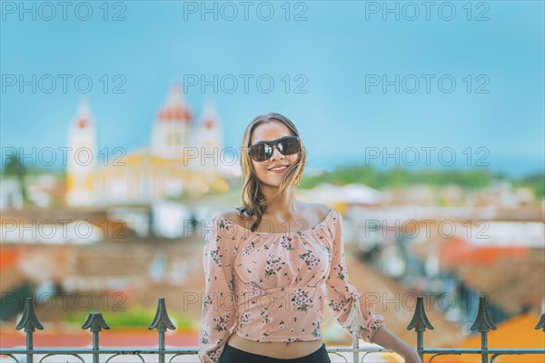 Happy young woman on vacation in Granada city, Nicaragua. Portrait of a beautiful tourist girl with