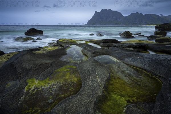Seascape on the beach at Uttakleiv (Utakleiv), in the foreground rocks and the so-called Eye of