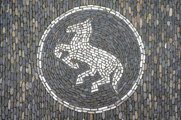 Jumping horse as a floor mosaic in Freiburg's historic city centre, Freiburg im Breisgau,