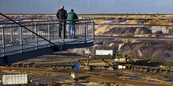 Two men on the Jackerath viewing platform look out over the Garzweiler open-cast lignite mine,