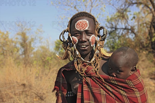 South Ethiopia, in Maco National Park, Mursi tribe, Mursi woman with baby, painted skin and