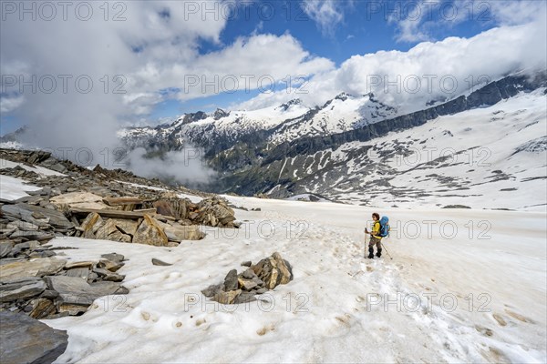 Mountaineer in a snowfield, descent from the summit of the Schönbichler Horn, view of snow-covered