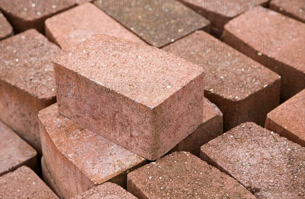Clay bricks piled up in builder's yard, UK