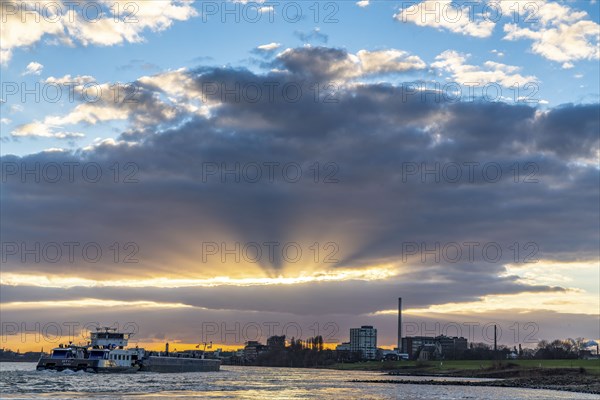Cargo ship on the Rhine between Duisburg and Krefeld, dramatic sunset, North Rhine-Westphalia,