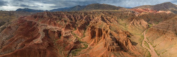 Eroded mountain landscape, canyon with red and orange rock formations, aerial view, Konorchek
