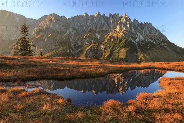 Rugged mountains reflected in a small mountain lake, autumn, evening light, Hochkönig, Mandlwand,