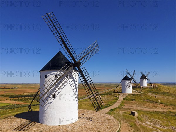 Traditional windmills in an open field under a clear blue sky, Mills, Alcazar de San Juan, PaÃ­s de