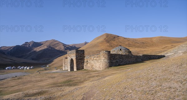Historic caravanserai Tash Rabat from the 15th century, with yellow hills, Atbashy district in the