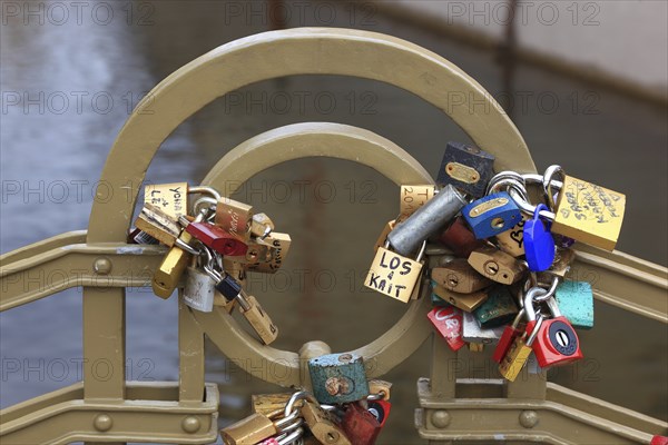 Lover's lock on a railing, love lock is a padlock which, according to custom, is attached to
