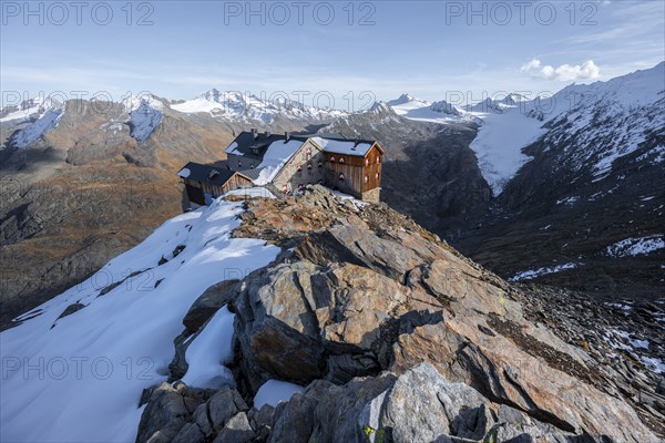 Snowy mountain landscape, mountain hut Ramolhaus in autumn with snow, in the evening light, view of