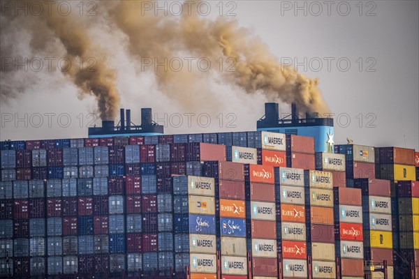 Container freighter Madison Maersk smoking chimneys of the ship's diesel engines, Maasvlakte 2,