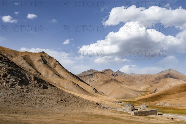 Historic caravanserai Tash Rabat from the 15th century, with yellow hills, Atbashy district in the