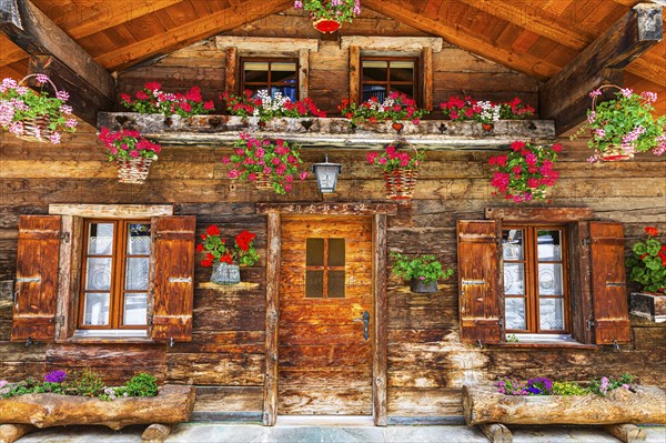Old wooden house with floral decorations, historic village centre, Grimentz, Val d'Anniviers,