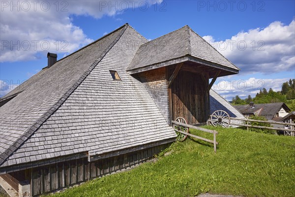 Entrance gate to a Black Forest house with old wagon wheels of the Resenhof Farm Museum in the
