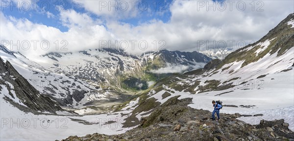 Mountaineer on hiking trail with snow, mountain landscape with summit Hoher WeiÃŸzint and