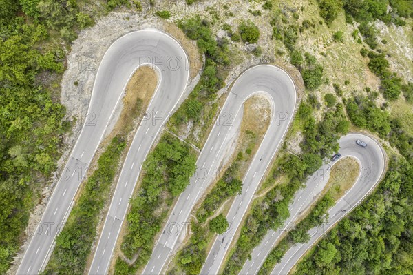 Aerial view, drone shot, Mountain pass road with multiple hairpins, water pipeline, Switzerland,
