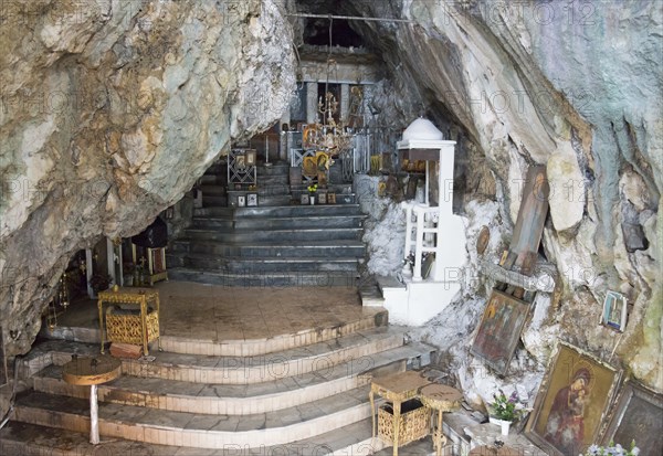 Interior view of a chapel built into the cave with steps and candles, rock church of Smerna, Church