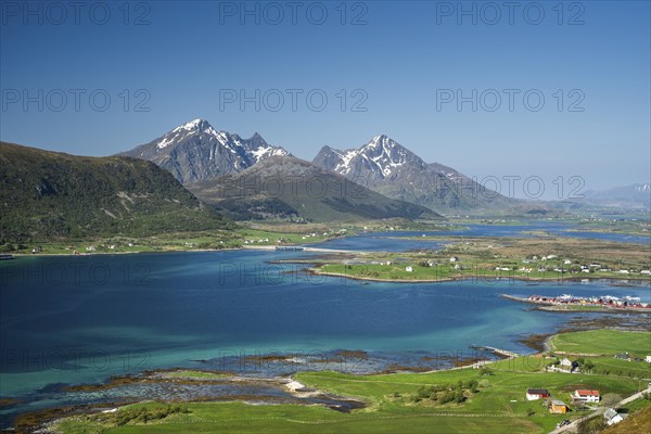 Landscape with sea and mountains, view from Hornsheia to Mount Himmeltindan. Good weather, blue sky