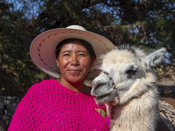 Indigenous woman of the Atacameno minority with llama, Atacama Desert, Chile, South America
