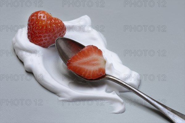 Strawberries with cream on a spoon