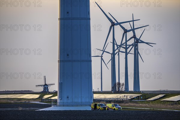 Windmill Poldermolen De Goliath stands between the high-tech wind turbines in Eemshaven, historic