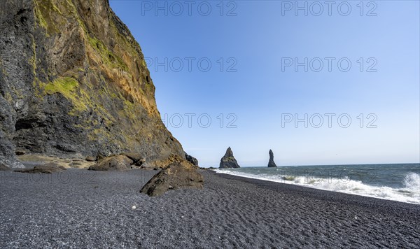 Black beach with cliffs, rock Reynisdrangar in the water, at Reynisfjara beach, Vik, South Iceland,