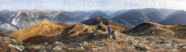 Panorama, mountaineer at the summit Kreuzjoch, view of summit Tschirgant and the Oberinntal and