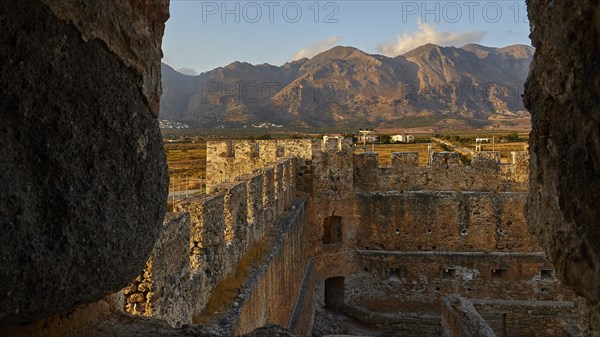 Evening light, battlements, courtyard, corner tower, mountains, Lefka Ori, White Mountains,