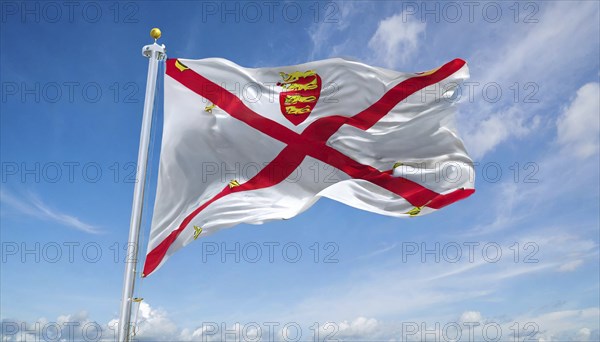The flag of the Isle of Jersey, Great Britain flutters in the wind