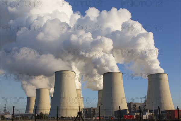 Steam rises from the cooling towers of the Vattenfall power plant in JÃ¤nschwalde, power lines and