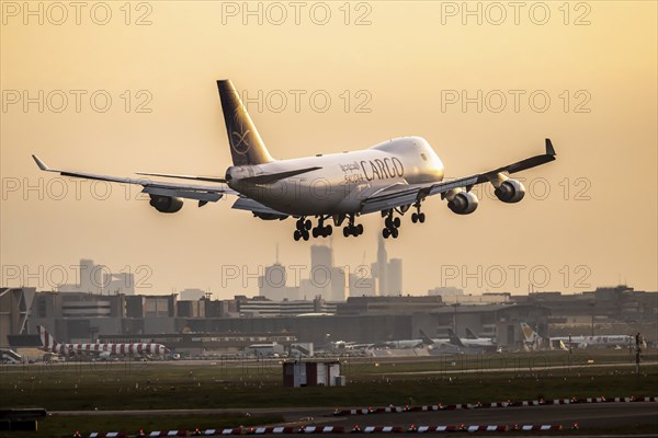 Aircraft shortly in front of landing at Fraport, dawn. Cargo aircraft of the airline Saudi Arabian