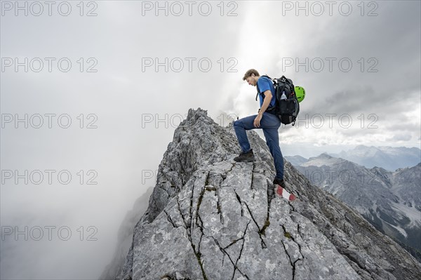 Mountaineer on a narrow rocky ridge, Watzmann crossing to Watzmann Mittelspitze, view of mountain