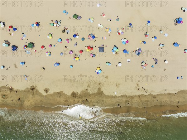 Beach life at the Atlantic Ocean near Punta Umbria. Aerial view. Drone shot. Huelva province,