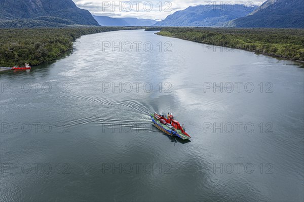 Aerial view of ferry crossing the river Rio Palena, connecting the road to Puerto Raul Marin