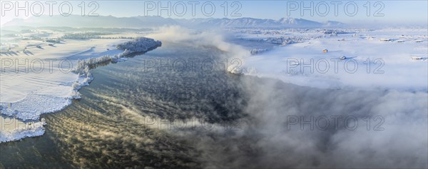 Aerial view of a lake in front of mountains, winter, snow, morning light, fog, panorama, Riegsee,