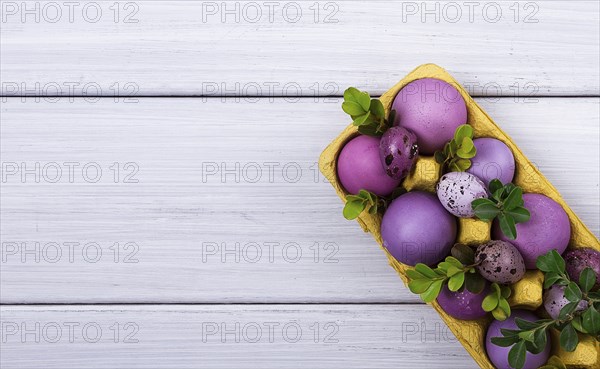 Easter eggs, purple and lilac, on a white wooden table, Easter card, banner, selective focus,