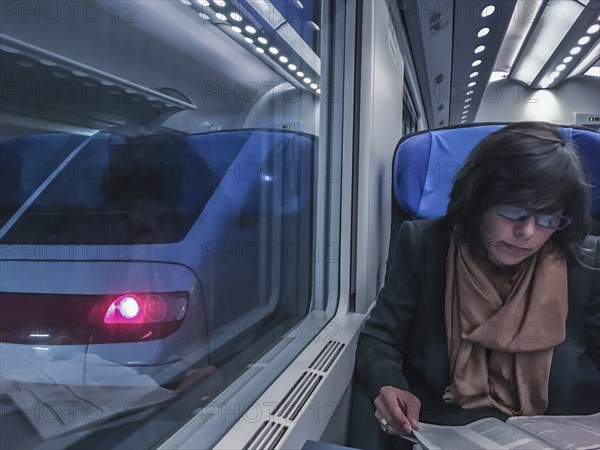 Woman Travel in a Train and Reading a Newspaper in Monte Carlo, Cote d azur, Monaco, Europe