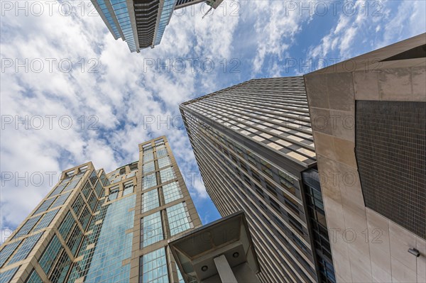 Clouds can be seen in the sky looking up between the skyscrapers in downtown Nashville, Tennessee,