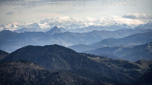 View of the Alpine foothills and main Alpine ridge with snow-covered peaks of the Zillertal Alps,