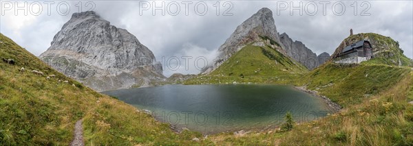 Panorama, Wolayersee and Alpine Club hut Wolayerseehütte, rocky cloudy mountains, Carnic Alps,
